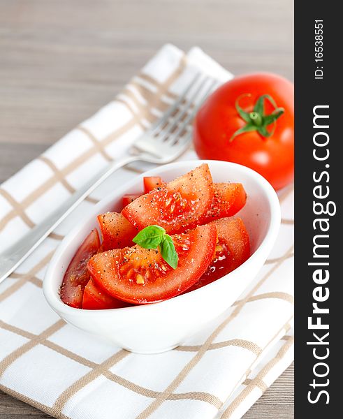Fresh tomato salad in a bowl with pepper. Fresh tomato salad in a bowl with pepper