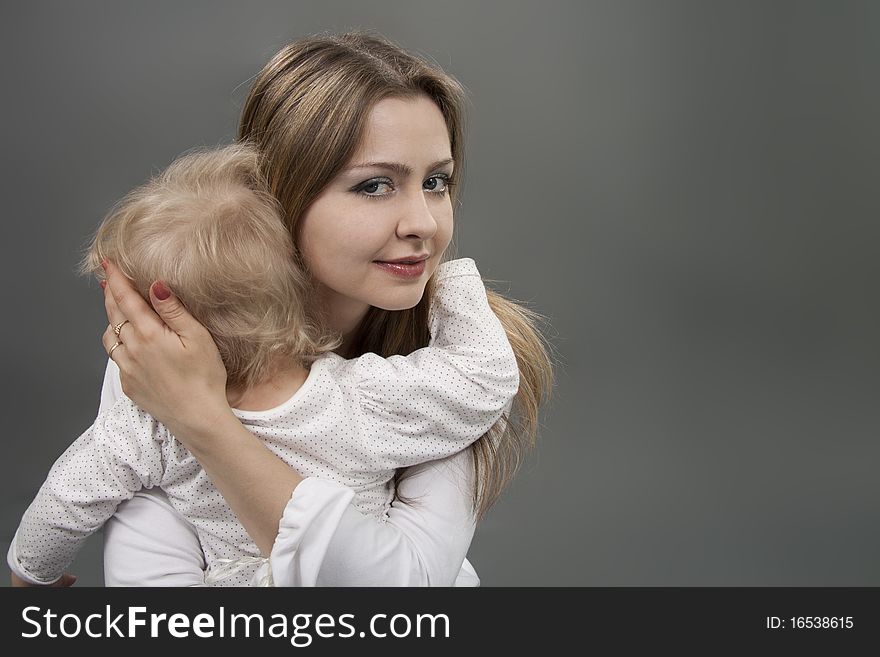 Little girl in mother's arms seeking protection and comfort. Little girl in mother's arms seeking protection and comfort