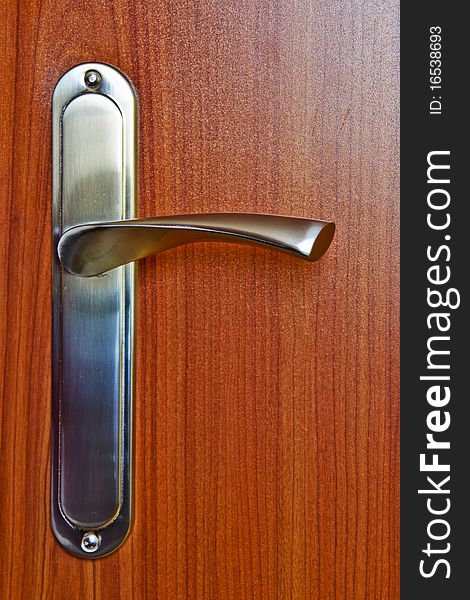 Silver handle on wood door