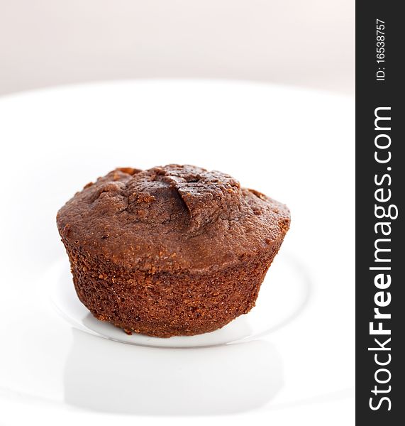Chocolate muffin on a white plate