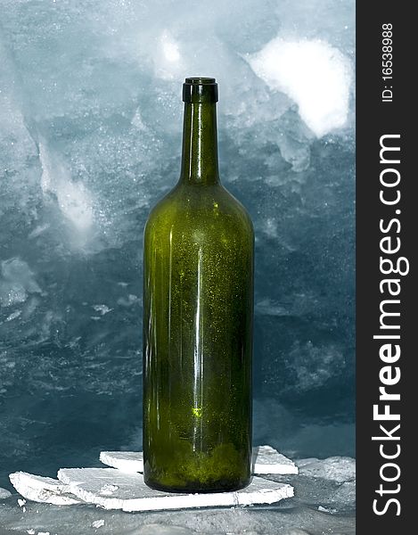 Empty green bottle on ice
