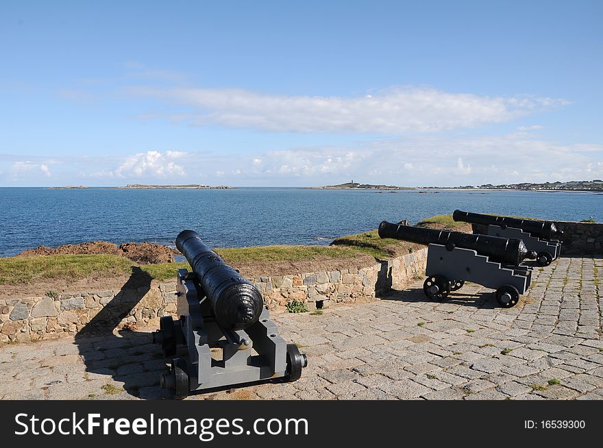 Cannons pointing out to sea at Portelet harbour, Guernsey. Cannons pointing out to sea at Portelet harbour, Guernsey