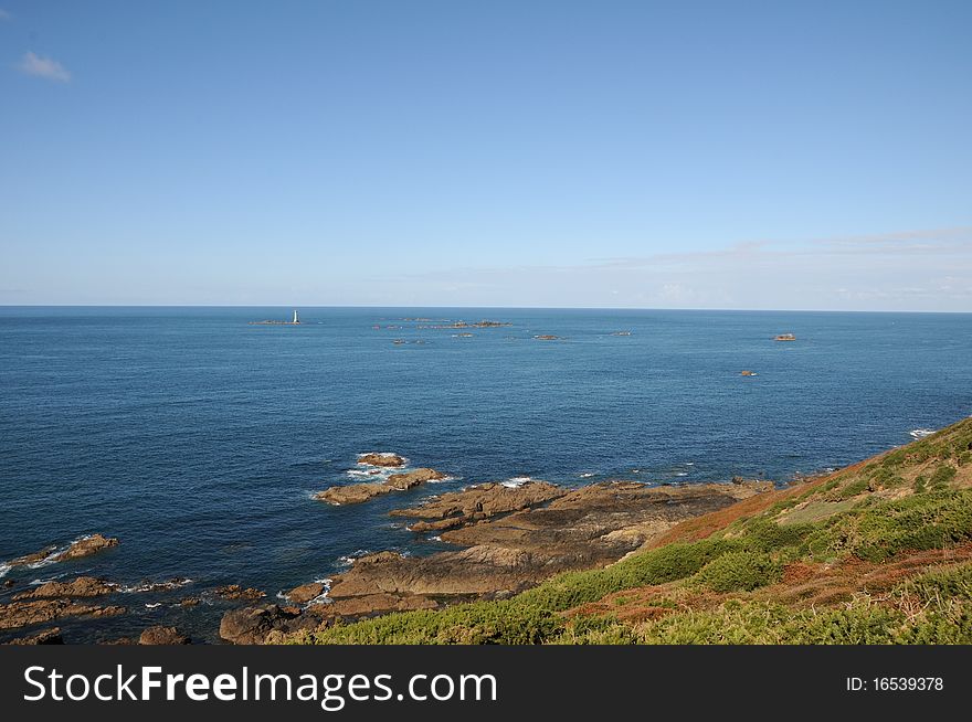 Coast of Guernsey at Torteval with lighthouse out at sea