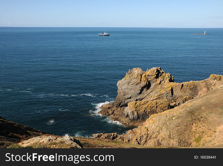 Coast of Guernsey at Torteval with lighthouse out at sea