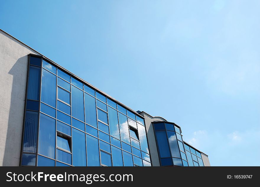 Office building. Modern skyscraper on the blue sky