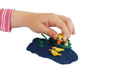 Child Hand Makes A Plasticine Composition Royalty Free Stock Image