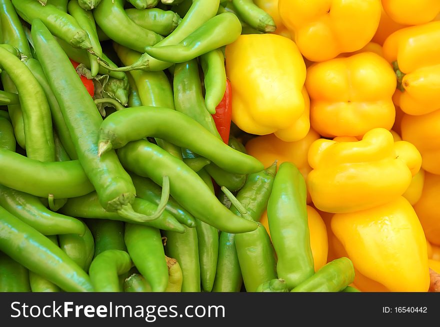 Close up of yellow and green peppers on market stand