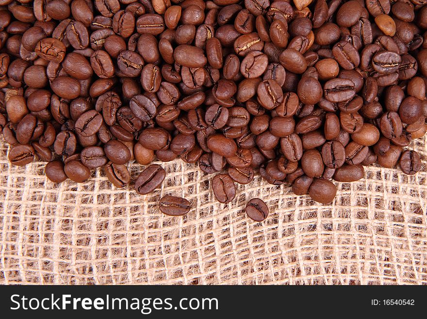 Coffee beans on burlap material in close up