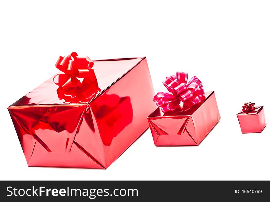 Row from red christmas gifts boxes with bows. Isolated on white. Row from red christmas gifts boxes with bows. Isolated on white