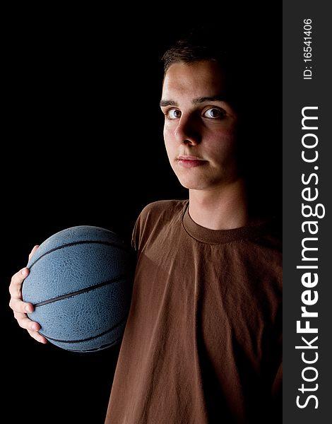 Young teenage basketball player in a studio setting with hip athletic clothing. Young teenage basketball player in a studio setting with hip athletic clothing.
