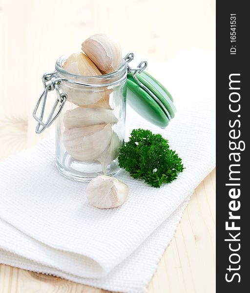 Fresh garlic in jar with parsley