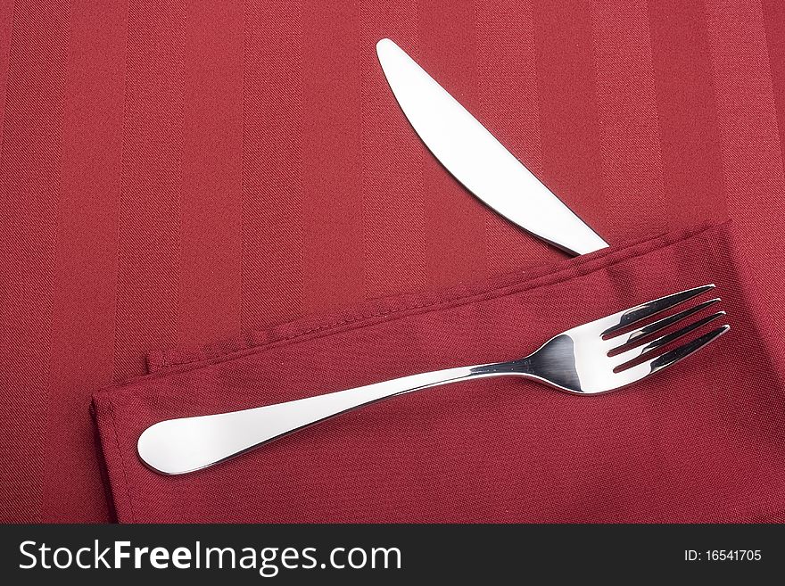 Knife and fork on a napkin as a dining room serving.