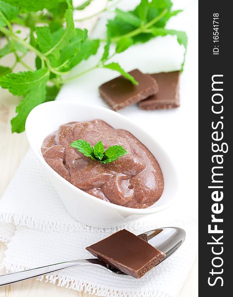 Fresh chocolate pudding in bowl with spoon