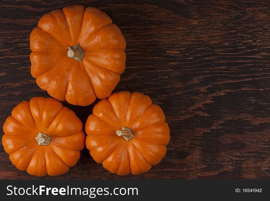 Small orange pumpkins symbolising autumn holidays and used in decorative works.