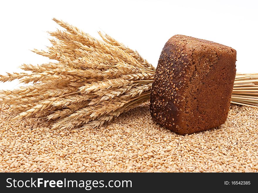 Bread with wheat and ears on white