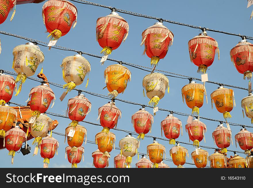 Rows Of Red Silk Lanterns Hanging Outside A Temple. Rows Of Red Silk Lanterns Hanging Outside A Temple