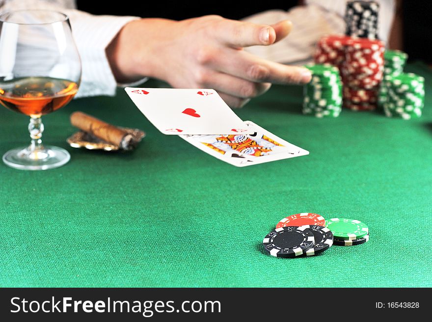 Man sitting at the gambing table and playing cards. Man sitting at the gambing table and playing cards