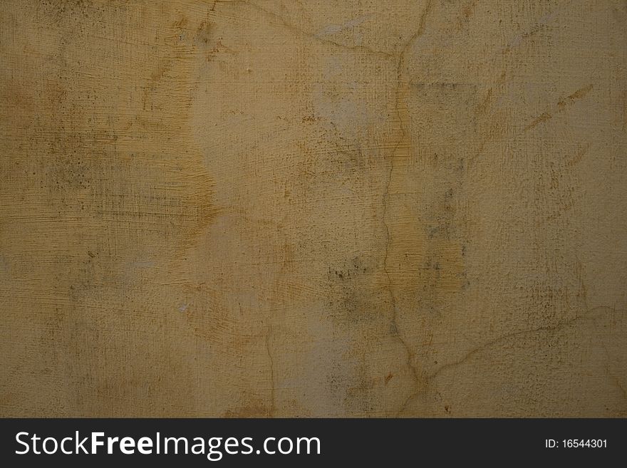 Sandy pale grey cracked plaster wall