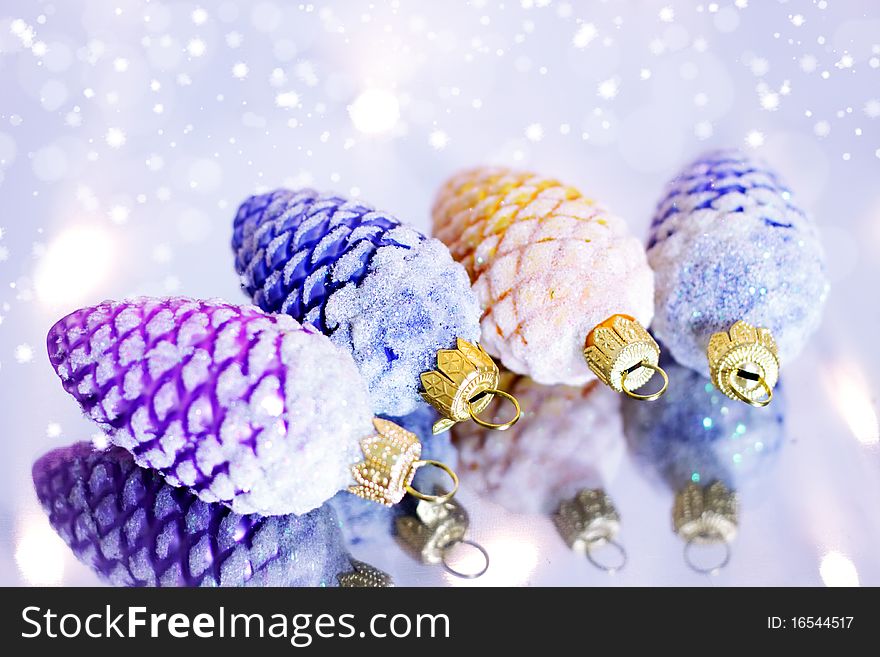 Four decorative pine cones and snowflakes