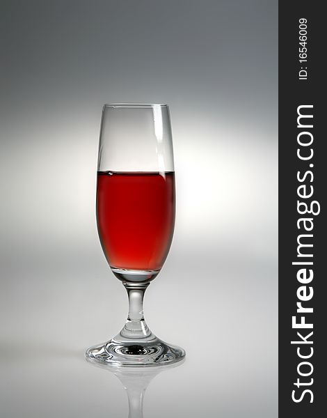 Glass of red wine on neutral background