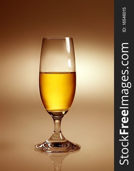 Glass with yellow drink in warm atmosphere. Glass with yellow drink in warm atmosphere