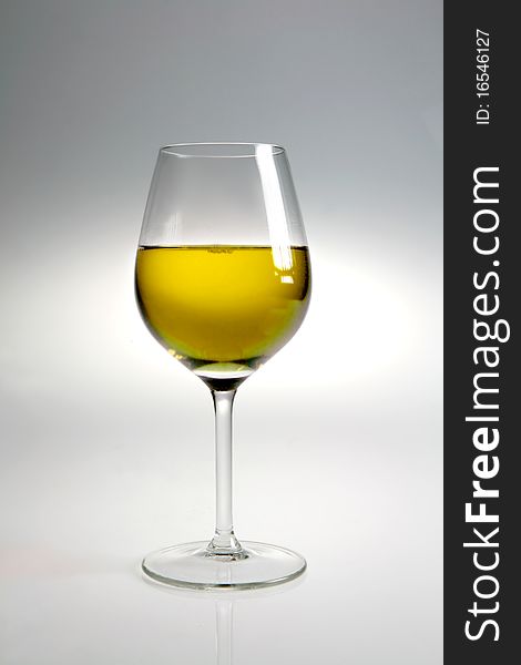 Glass with white wine on neutral background