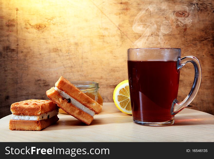 Hot tea with wafers and a lemon. Hot tea with wafers and a lemon