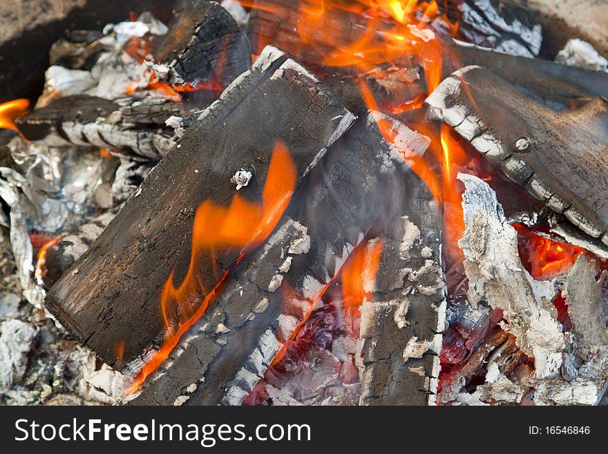 Hot embers from an evening campfire.