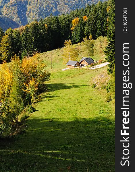 Small wooden lodge with grassland in the mountains of the Hochbaerneck in Lower Austria on a sunny autumn day. Small wooden lodge with grassland in the mountains of the Hochbaerneck in Lower Austria on a sunny autumn day