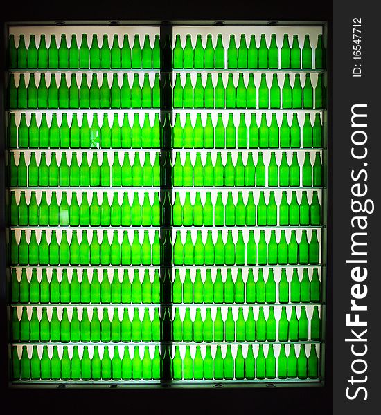 The silhouette rows of the green bottles.