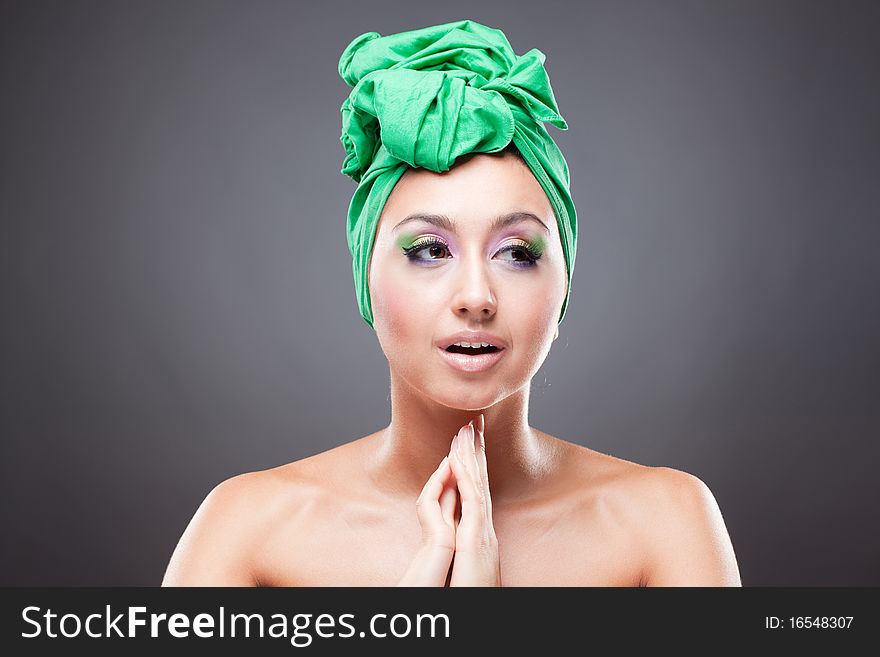 Hoping beautiful young woman with pink-green makeup in green hat
