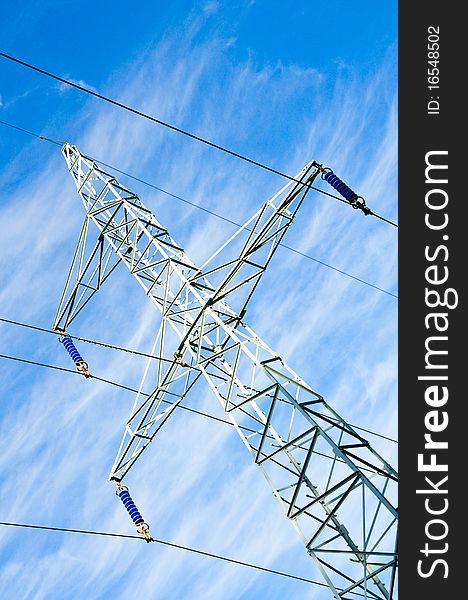 Pylon and transmission power line on blue sky background