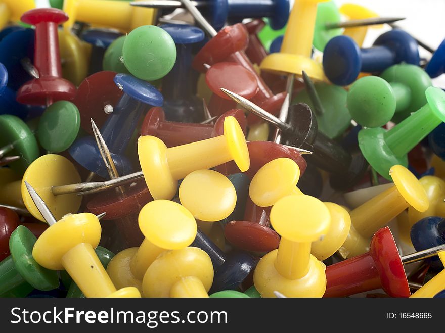 Heap of multicoloured drawing-pins closeup