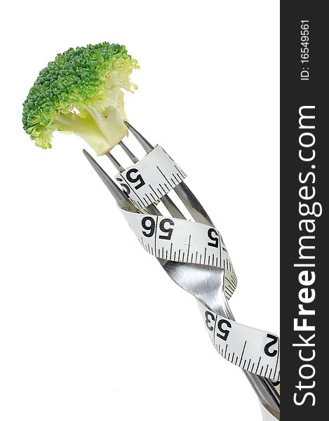 Broccoli on a fork wrapped with a tape measure. Broccoli on a fork wrapped with a tape measure