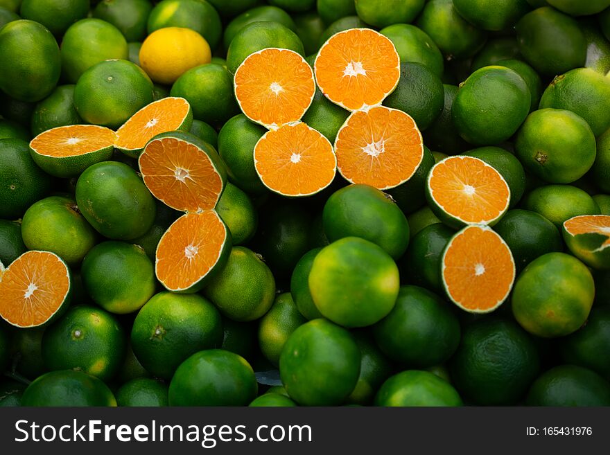 Freshly picked green tangerines mandarines, clementines, as Citrus fruit background. Freshly picked green tangerines mandarines, clementines, as Citrus fruit background
