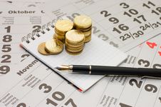 Sheets Of A Calendar With Coins And A Notebook Royalty Free Stock Photography Sheets Of A Calendar With Coins And A Notebook Royalty Free Stock Photography