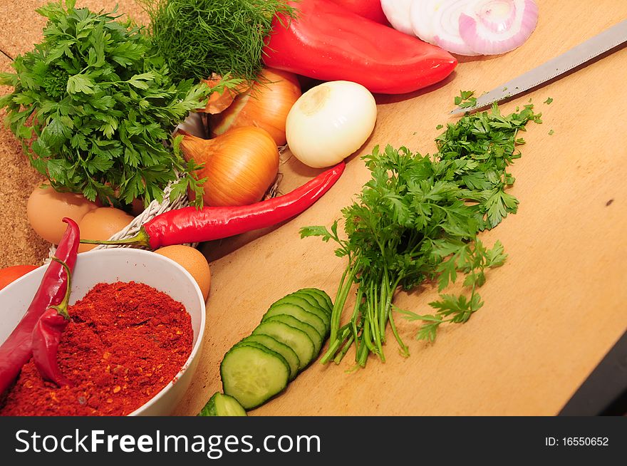 Fresh vegetables on the table and finely chopped parsley. Fresh vegetables on the table and finely chopped parsley