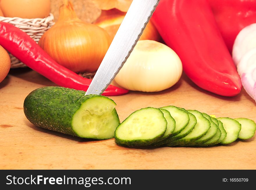 Fresh vegetables on the table and chopped cucumber. Fresh vegetables on the table and chopped cucumber