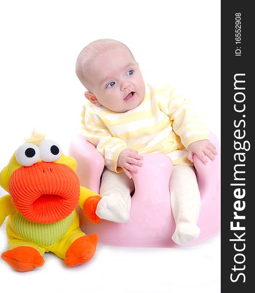 Photograph of cute baby with toy isolated against white