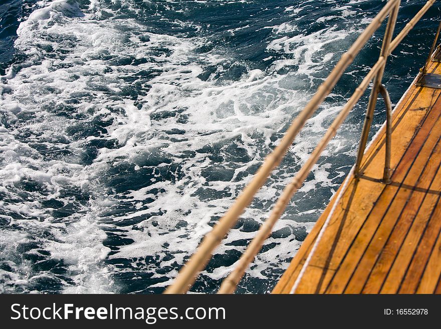 Summer series: modern wooden yacht in the sea. Deck view