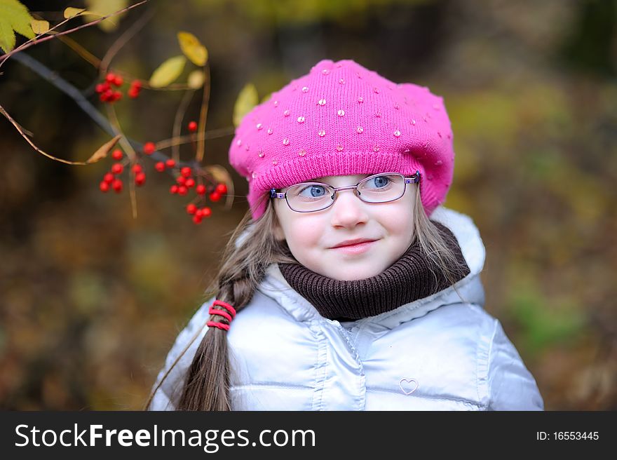 Adorable small girl in bright pink hat