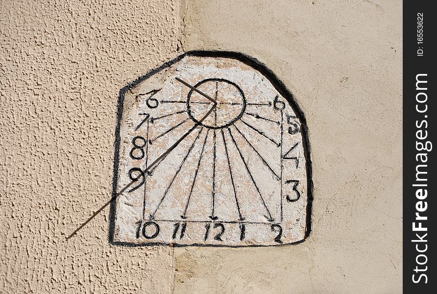 Sun Dial Clock on Cement Wall