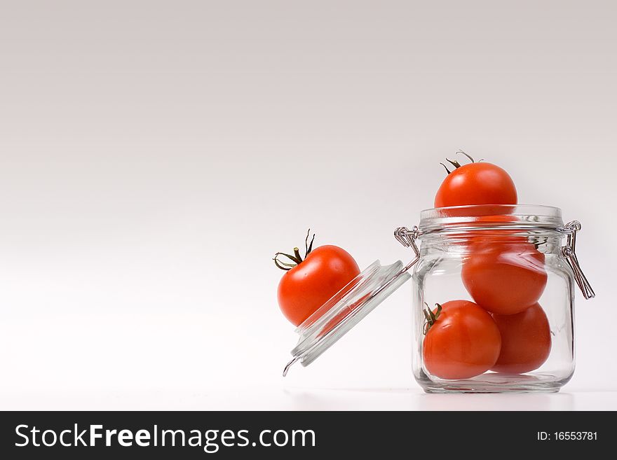 Happy tomatoes jumping in a jar. Happy tomatoes jumping in a jar