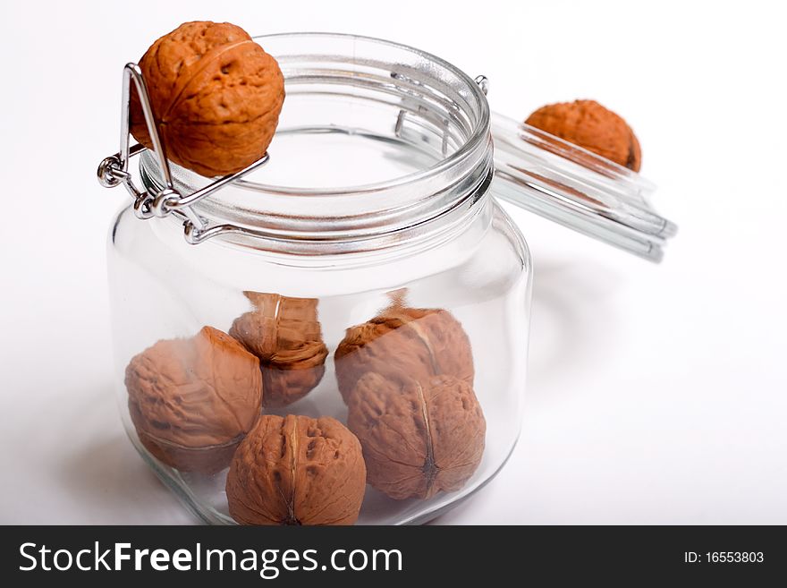 Some walnuts in a glass jar. Some walnuts in a glass jar