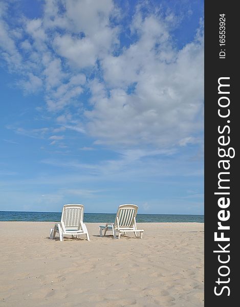 Two white chairs on Hua Hin beach under the blue sky. Two white chairs on Hua Hin beach under the blue sky