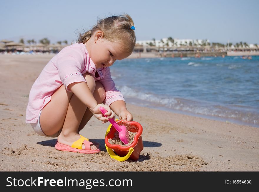 Little Girl Plays On Seacoast