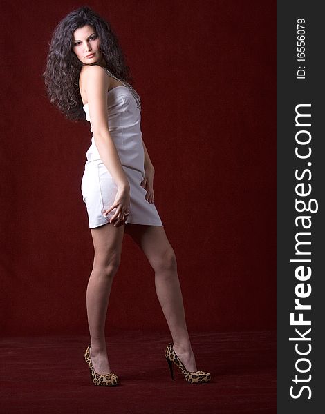 Fashion model posing in white dress