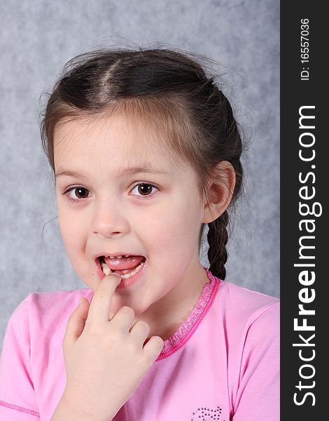 The scared little girl with a finger in a mouth. The scared little girl with a finger in a mouth