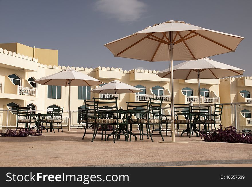 Sunshades and parasols in front of the luxury arabic hotel