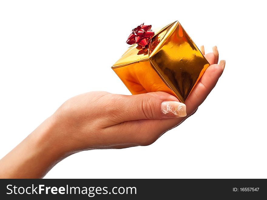 Female hand holding a gold christmas gift. Isolated on white. Female hand holding a gold christmas gift. Isolated on white